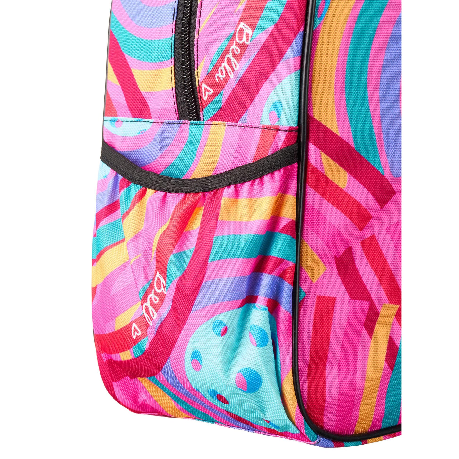 Close-up view of a pink duffel bag featuring a vibrant abstract pattern of colorful stripes and circles. The bag has a black zippered pocket.