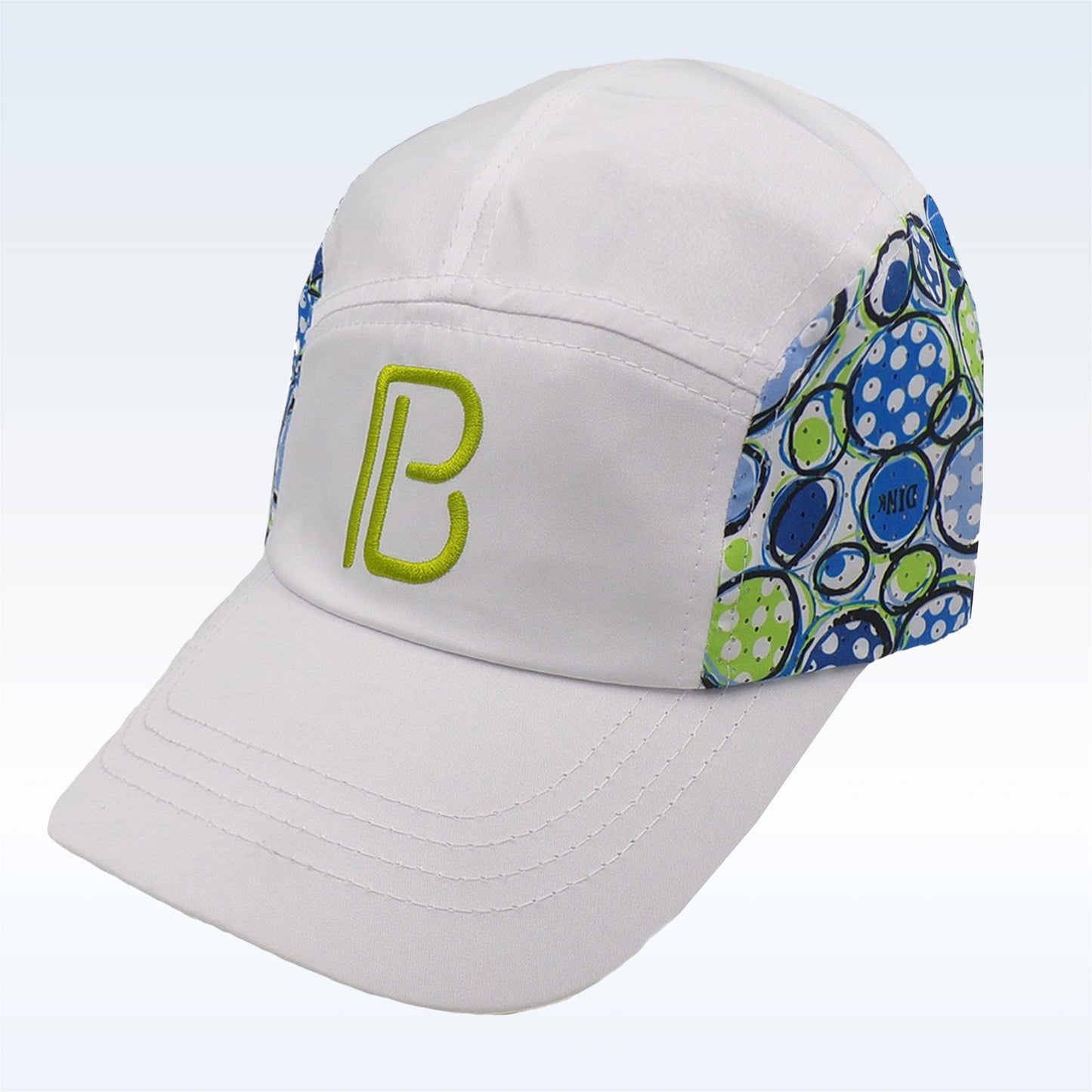 White baseball cap with blue and green abstract pattern on the side panel and a green "B" embroidered on the front.