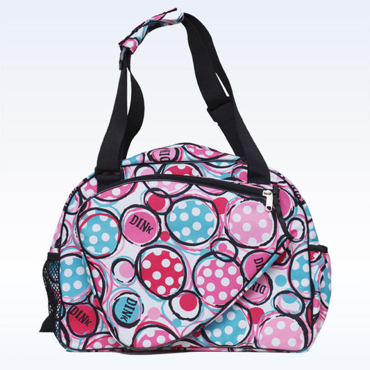Pink and blue polka dot duffel bag with black straps and accents.