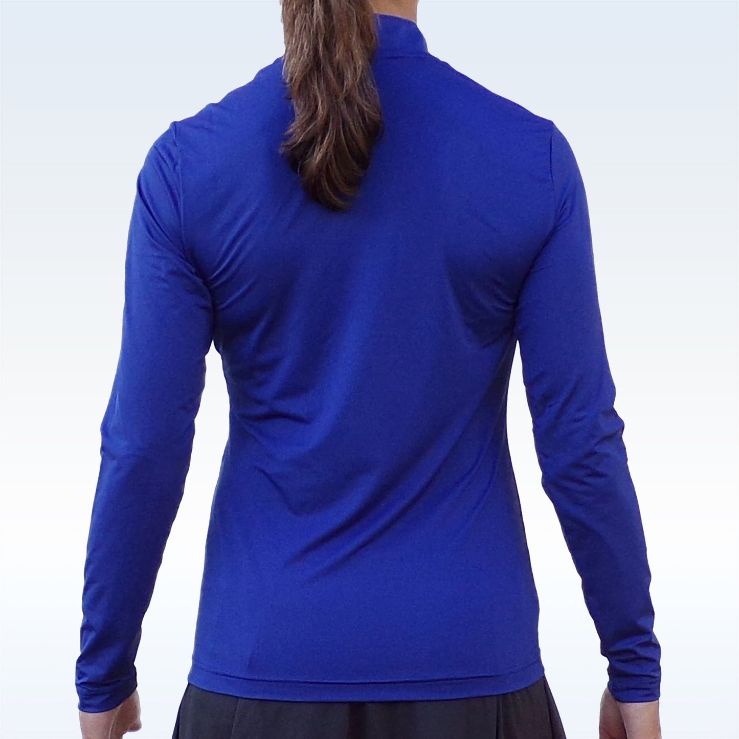 Woman models a royal blue long-sleeve athletic top with quarter-zip closure.