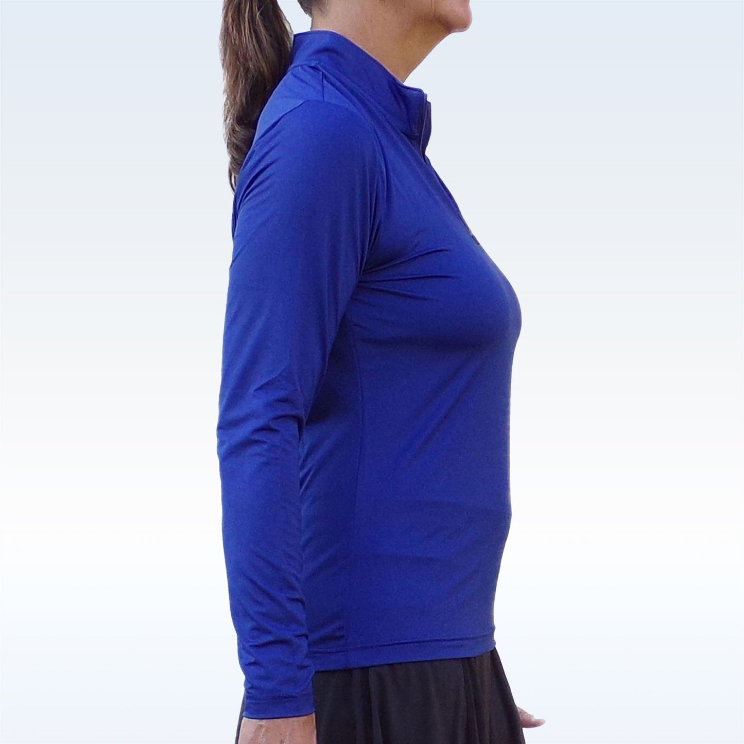 Woman models a royal blue performance shirt with quarter-zip collar, showcasing its athletic fit.