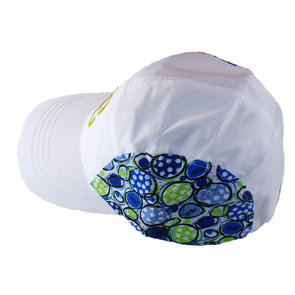 White baseball cap with blue and green abstract pattern on back panel, shown at an angle. 
