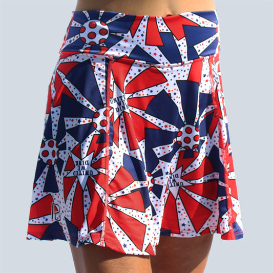 Woman models a red, white, and blue athletic skirt with a repeating starburst pattern. 
